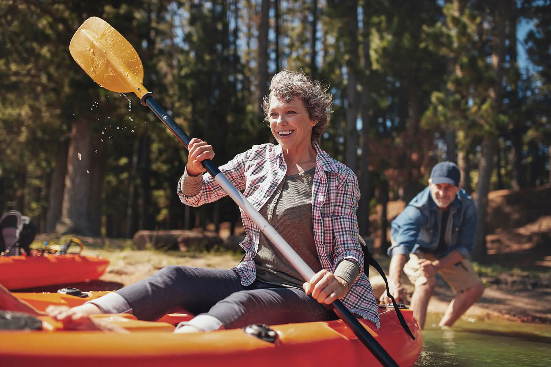 Old woman happily kayaking